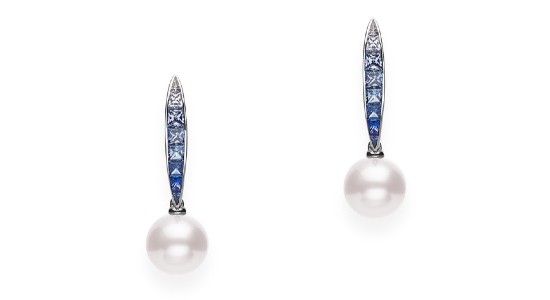 a pair of pearl drop earring with sapphire accents