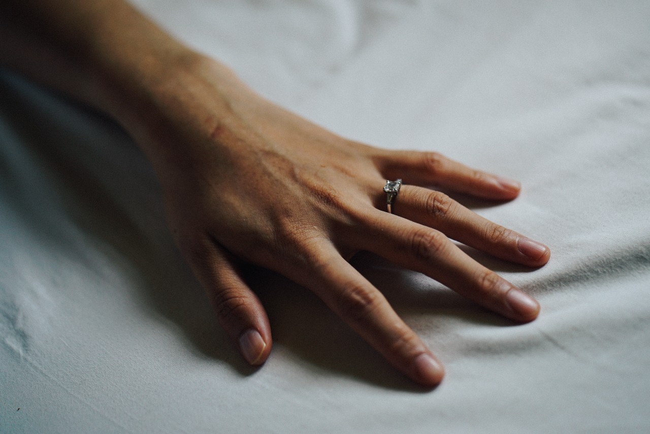 Resting ladie’s hand with a square cut diamond engagement ring