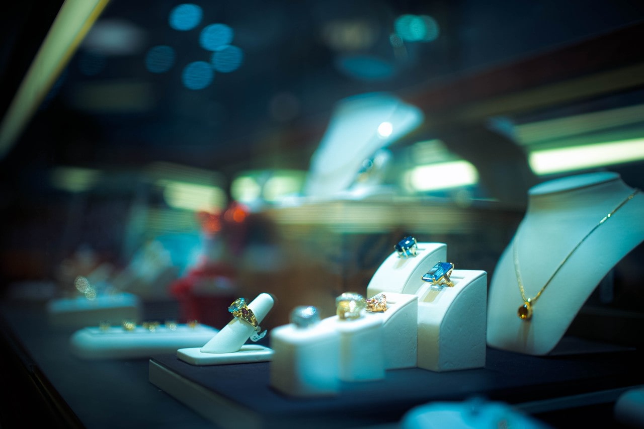 A close-up of an elegant jewelry display under low light.