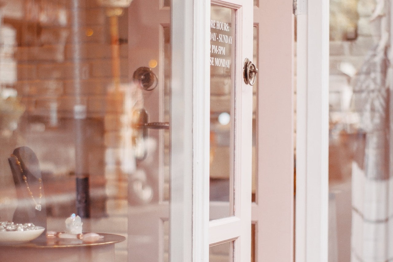 A picturesque jewelry storefront, its door slightly ajar.