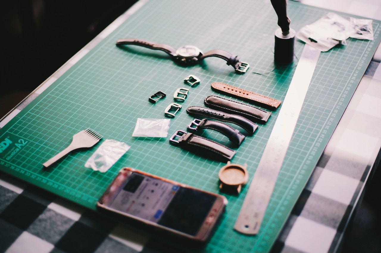 An overhead view of a craftsman’s workspace as they prepare to service a luxury watch.